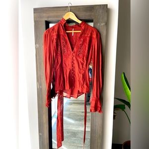 Red, light weight, dress up blouse from Free People. Size small.